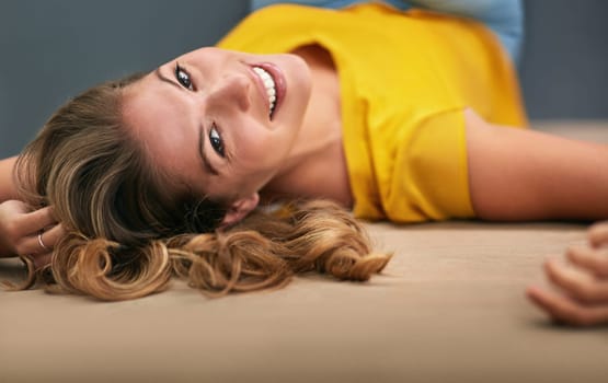 Portrait, smile and woman on ground, happiness and relaxing with confidence, home and peaceful. Face, person and girl on floor, joyful and calm thoughts with mindset, chilling and carefree weekend.