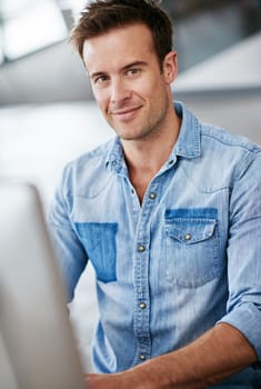 Portrait, creative and business man in office startup, company or workplace for career in Switzerland. Professional, entrepreneur and face of confident employee, worker or editor on computer at job.