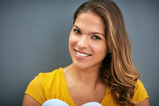 Wall, smile and woman with tshirt, portrait and relax for weekend, Gen z and streetwear for fashion in house. Grey background, happiness and girl in apartment, cheerful and comfortable in home.