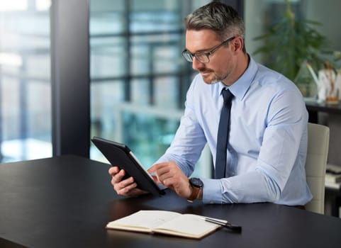 Businessman, tablet and notebook in office typing for communication, corporate research and company information. Technology, male person and working on online plan for website, social media or sales.