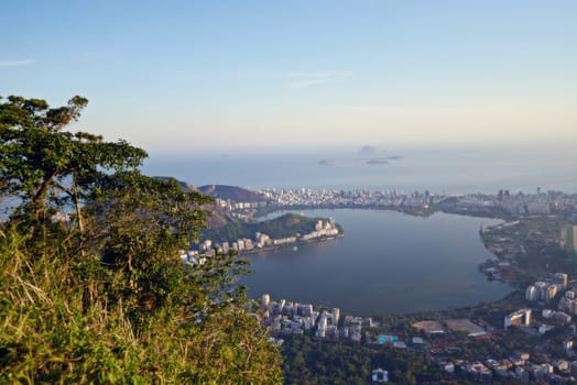 City, ocean and nature with vacation, drone and Rio De Janeiro for summer holiday, getaway trip and aerial view. Landscape, location and beach with buildings, urban town and outdoor with sunshine.