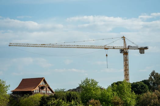 Construction crane working on large construction site