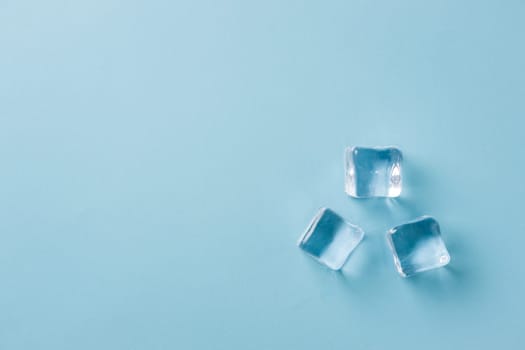 top view of ice cubes of different sizes on blue background