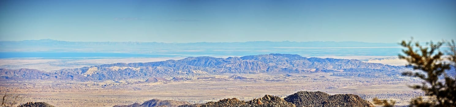 California, desert and landscape with panorama, enviroment and blue sky for travel or tourism. Nature, mountain and land for cactus, scenery and usa sunshine with summer banner and outdoor harmony.