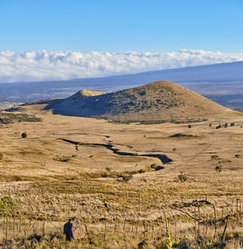 Desert, mountain and banner of landscape in nature, countryside or journey to inactive volcano in Hawaii. Hill, field and travel to bush in valley with grass, plants and clouds on horizon in blue sky.