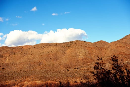 Landscape, mountain and dry in countryside as wallpaper with nature for conservation, sustainability and environment in Texas. Desert, drought in summer with climate change, natural and hot weather.