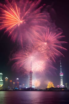 Fireworks show in the night sky over the high towers and river. New Year's fun and festivities. A time of celebration and resolutions.