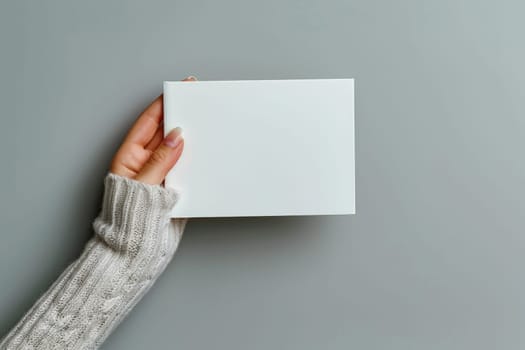 Hand holding white blank book mockup, isolated