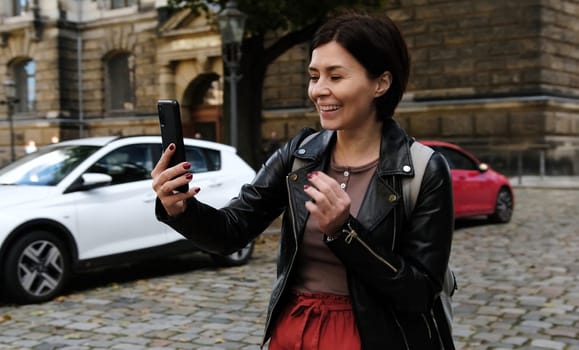 Attractive Woman Explores Touristic Places Of Dresden While Chatting On Messenger