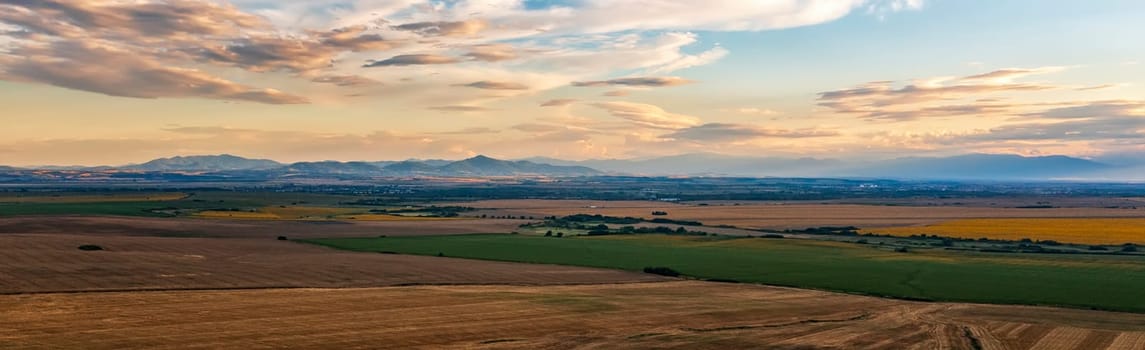 Stunning aerial panorama of beautiful autumn fields , and colorful sunset sky