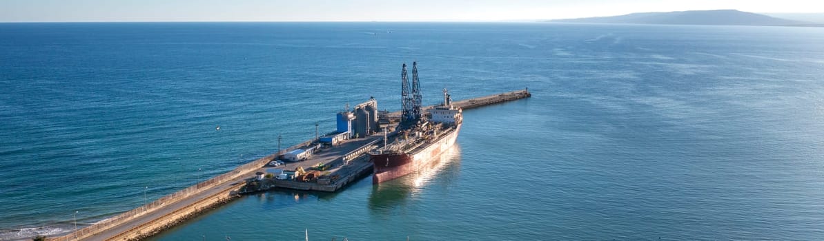 Ship of the industrial port. panoramic view from a drone. Concept export or import 