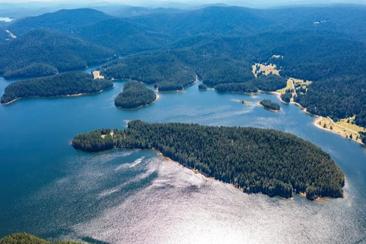 Amazing aerial view of a small island at Dam Shiroka Polyana, Bulgaria