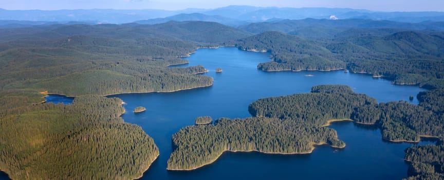 Beautiful panorama of blue water and green forest. Aerial view at Dam Shiroka Poliana, Bulgaria.