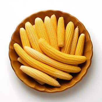 Yellow corn cobs in a bowl, top view. Corn as a dish of thanksgiving for the harvest, picture on a white isolated background. An atmosphere of joy and celebration.