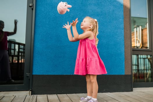 Child with hearing problem and cochlear implant dance in street, deaf kid began to hear. Hearing loss in childhood and treatment concept. Copy space and empty place for text.