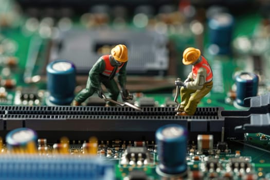 Selective focus of miniature engineer and worker fixed and maintenance mainboard computer