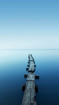 Old wooden jetty extending into a calm blue sea