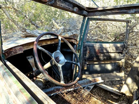 Steering Wheel and View Inside an Abandoned Old Car in the Desert. High quality photo