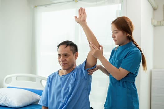 A sick caregiver or young nurse is helping a patient who is rehabilitating with physical therapy at the hospital..