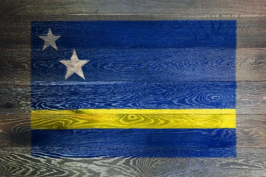 A Curacao flag on rustic old wood surface background