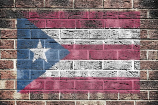 A Puerto Rico flag on old brick wall background red white stripe blue star