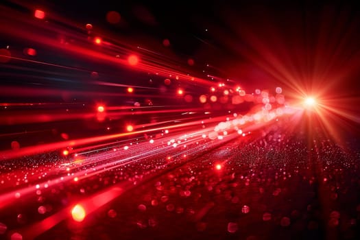 A red streak of light is shown in the image, with a blurry background. Concept of motion and energy, as if the light is traveling through space. The red color of the streak adds a sense of warmth