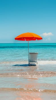 Bright orange beach umbrella and chair in shallow ocean water