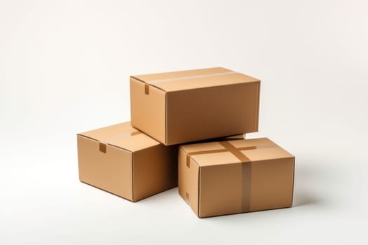 Three cardboard boxes stacked on top of each other. The boxes are brown and have a white background