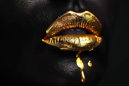 A woman's face is covered in gold glitter.