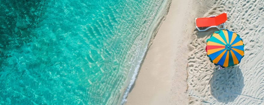 Aerial view of a tropical beach with a colorful umbrella and a sun lounger