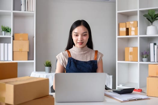 SME business entrepreneurs small in Asia Preparing cardboard boxes in home office Small business operators preparing to ship to customers.