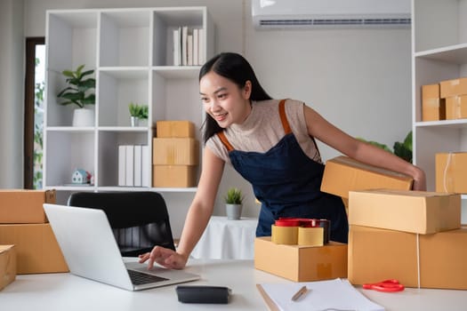 SME business entrepreneurs small in asia Preparing cardboard boxes in home office Small business operators preparing to ship to customers.