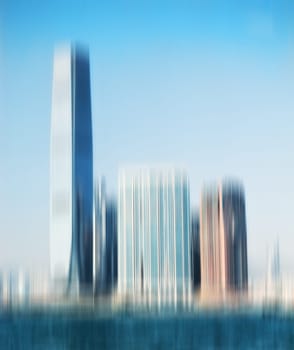 City, buildings and motion blur with skyscraper for background, architecture and urban structure. Blue sky, empty and town with daylight for travel destination, construction and development in Dubai.