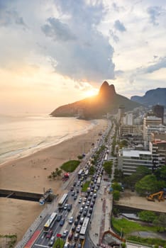 Beach, city and coastal with mountain or building infrastructure or architecture, travel or ocean. Vacation, sand and shoreline in Rio de Janeiro or urban location for Brazil trip, sunset or summer.