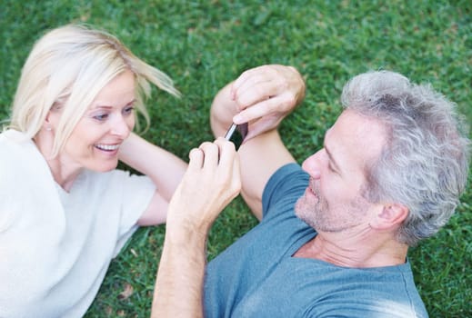 Mature, couple and cellphone picture in nature for relationship memory, photography or grass. Man, woman and smartphone photo of wife in backyard with holiday travel in Florida, relax or marriage.