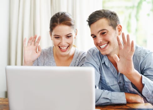 Video call, home and couple with greeting, laptop and connection with internet, communication and webinar. Apartment, relax and man with woman, online gathering and virtual meeting with hand gesture.