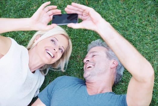 Mature, couple and selfie smile on grass from above in garden backyard for social media post, memory or travel. Man, woman and happiness for profile picture from holiday trip, vacation or connection.