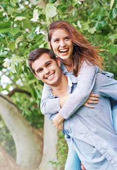 Happy, portrait and couple piggyback outdoor on date in garden, park or adventure on holiday or vacation. People, relax and play a game in backyard or fun partner support woman with ride on back.