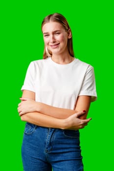 Portrait of an upset young casual girl against green background in studio