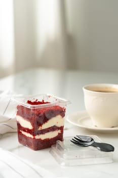 Trifle red velvet in plastic cup on table close up