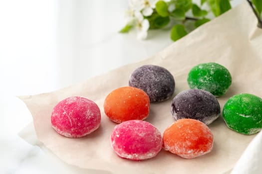 Multi-colored Japanese cakes Mochi in a white plate close up