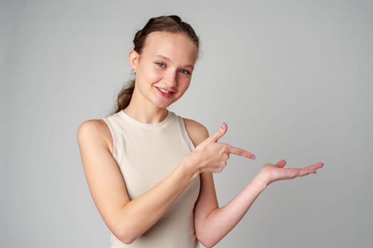 Woman in White Top Pointing at Something in studio