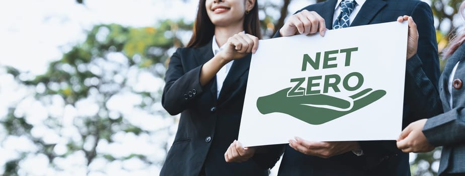 Group of business people stand united, holding eco-friendly idea and concept for environmental awareness campaign by business corporate to embrace net zero emission and environmental friendly. Gyre