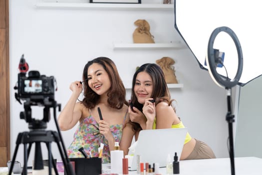 Woman influencer shoot live streaming vlog video review makeup uttermost social media or blog. Happy young girl with cosmetics studio lighting for marketing recording session broadcasting online.