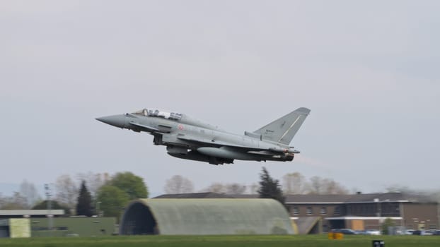 Istrana Italy April 5 2024: NATO Combar Aircraft at Low Altitude After Take Off from a Military Airport. Eurofighter Typhoon of Italian Air Force. Copy Space.