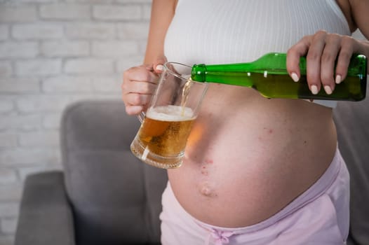 Faceless pregnant woman pouring beer into a glass