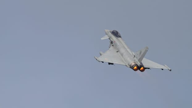 Istrana Italy April 5 2024: Supersonic Fighter Jet Climbs with Full Engine Power to Intercept a Thread. Eurofighter Typhoon of Italian Air Force. Copy Space.