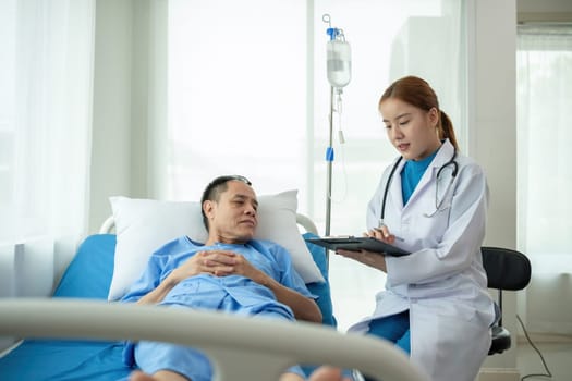 A female doctor is examining the body and taking notes on a sick person in a hospital examination room..