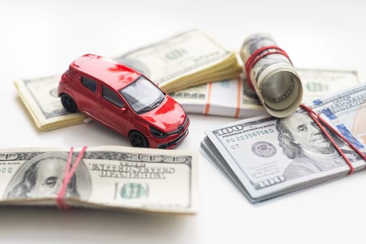 Small decorative car model, a lot of cash dollars of USA, credit for car concept. High quality photo