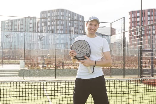 man playing paddle tennis court. High quality photo